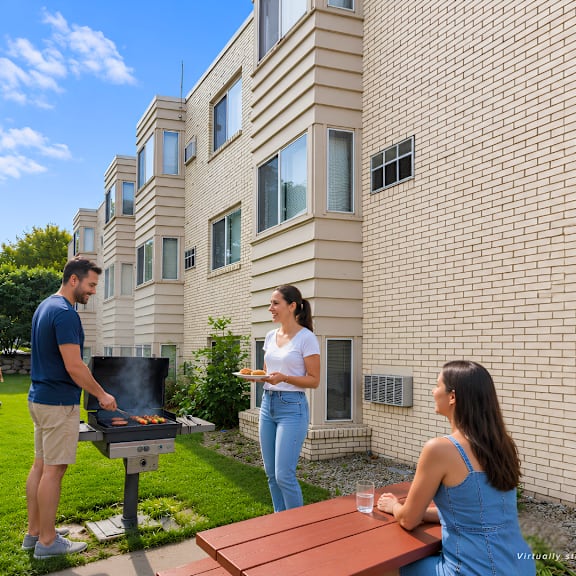 a man grilling in a backyard with a woman and children playing in the background.