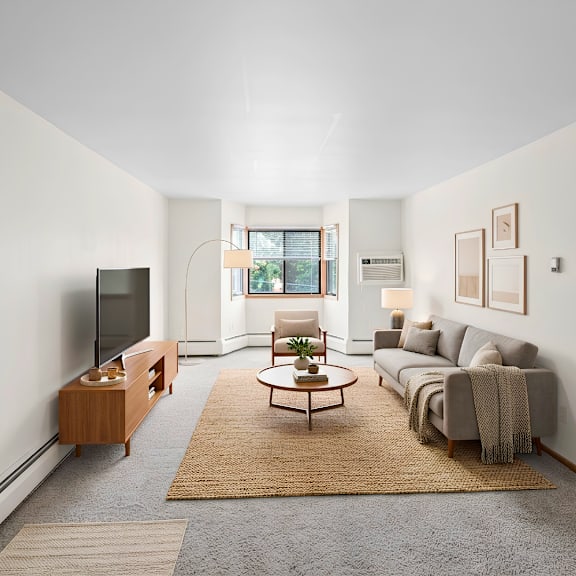 a living room with a grey couch and a wooden coffee table.