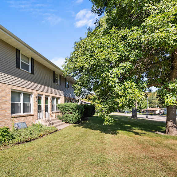 a house with a green lawn in front.