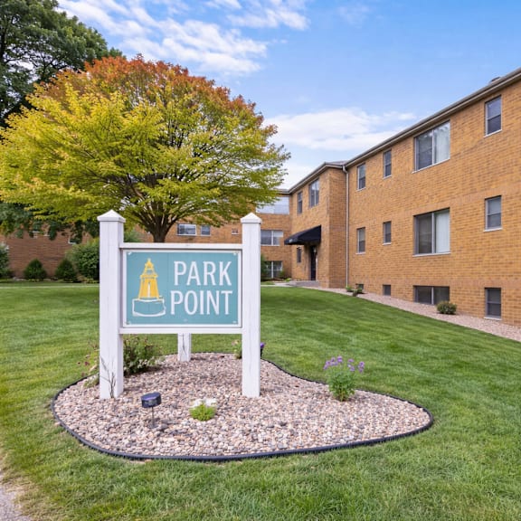 a sign that says park point stands in front of a brick building.