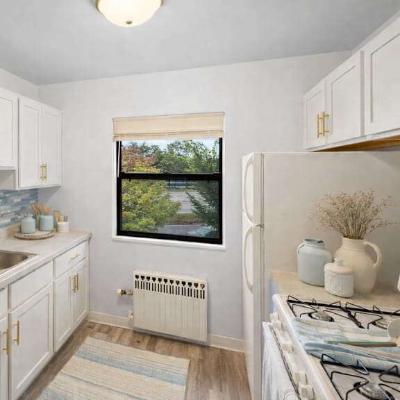 a kitchen with a window overlooking a bridge.