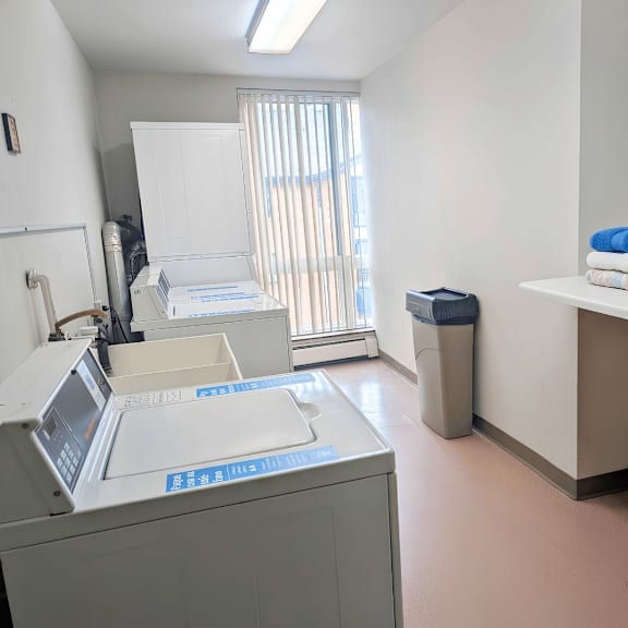 a medical office with a white cabinet, a blue towel, and a poster on the wall.
