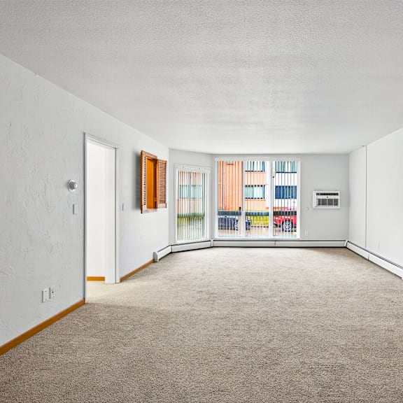 a room with white walls and a carpeted floor.