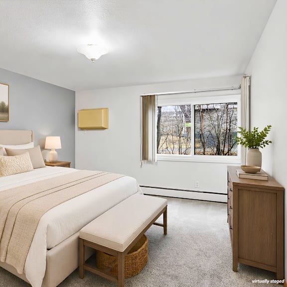 a bedroom with a large bed, nightstands, and a window.