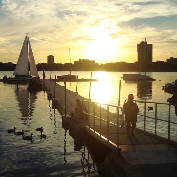a serene sunset view at a marina with people enjoying the view.