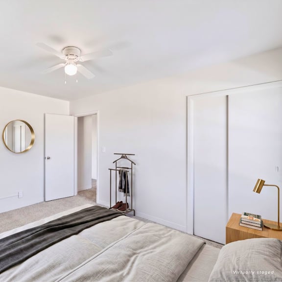 a bedroom with a bed, a dresser, and a mirror.