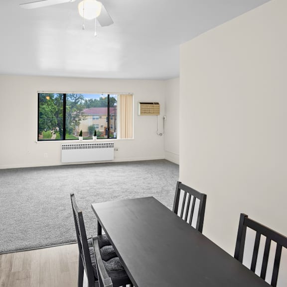 a dining room with a table and chairs.