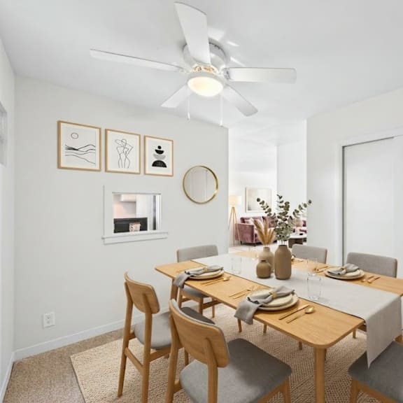 a dining room with a table set for six people.