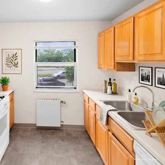 a kitchen with white appliances and wooden cabinets.