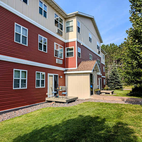 a red building with a white garage door and windows.