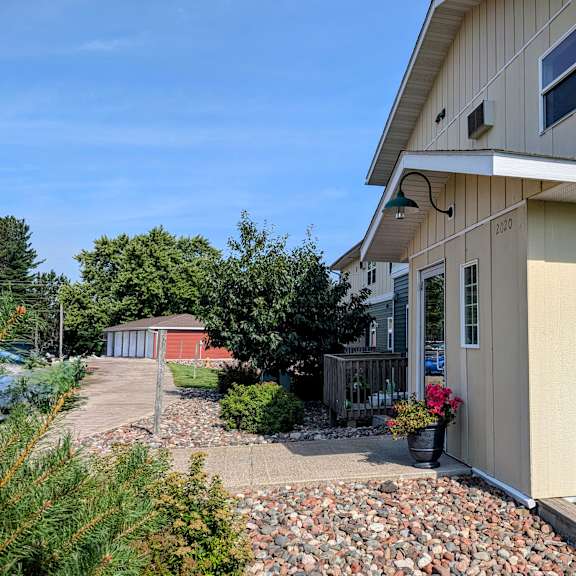 a house with a red shed in the background.
