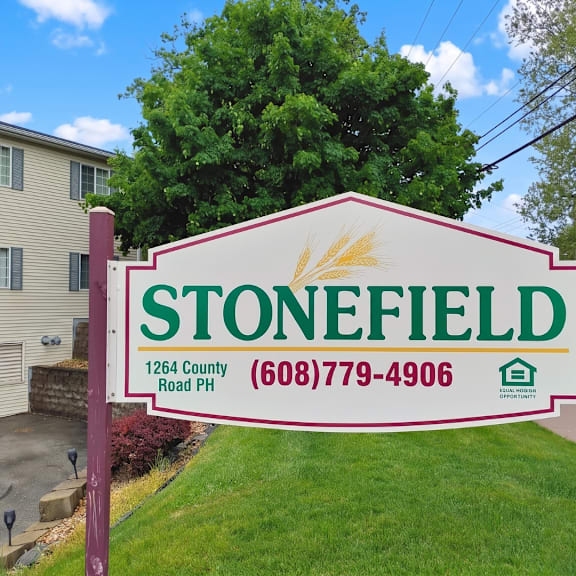 a sign for stonefield with a phone number on it.