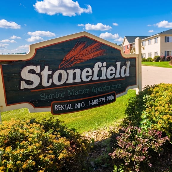 stonefield senior manor apartments sign with a phone number for rental information.
