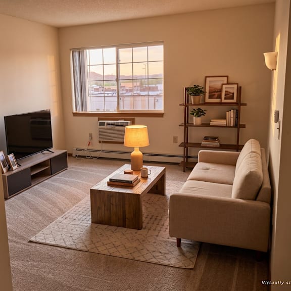 a living room with a couch, coffee table, and a television.