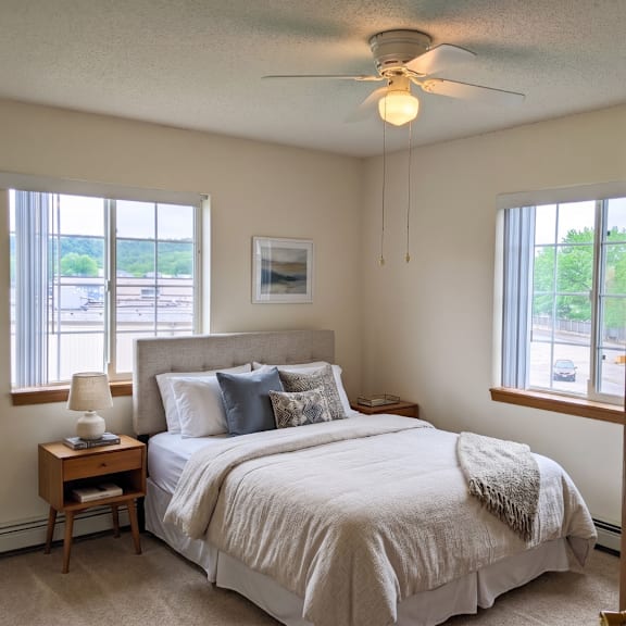 a bedroom with a large bed and a ceiling fan.