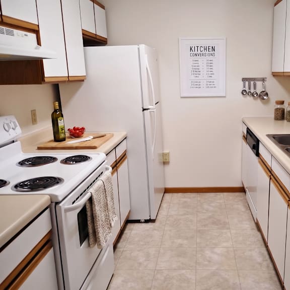 a kitchen with white appliances and a white refrigerator.