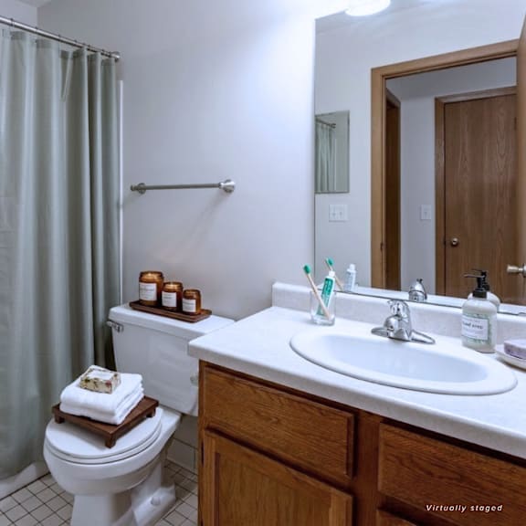 a white bathroom with a toilet, sink, and bathtub.
