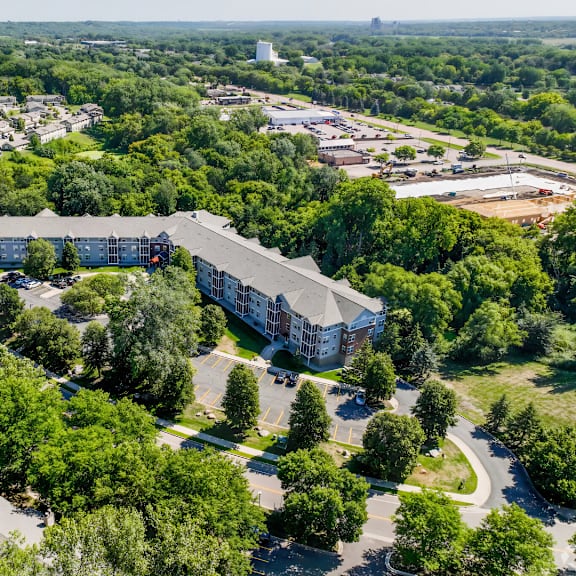 a large building surrounded by trees is the main focus of this aerial image.