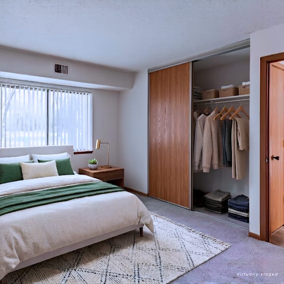 a bedroom with a large bed and a wardrobe.