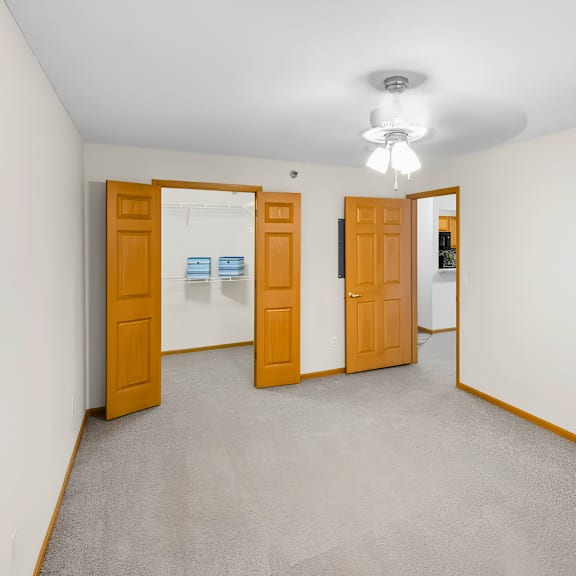 a room with two doors and a carpeted floor.