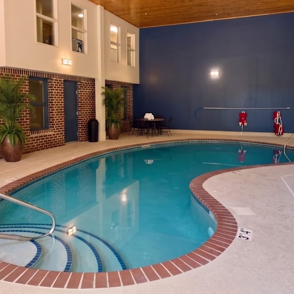 a swimming pool inside a house with a blue wall.