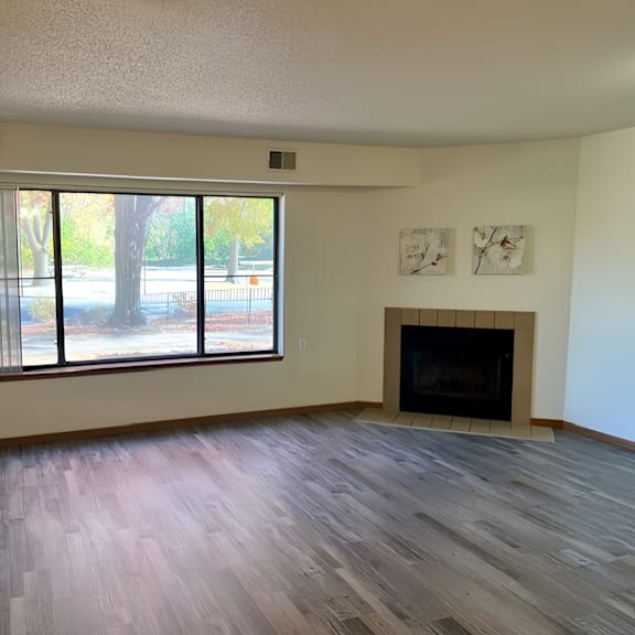 a room with a fireplace and a large window.