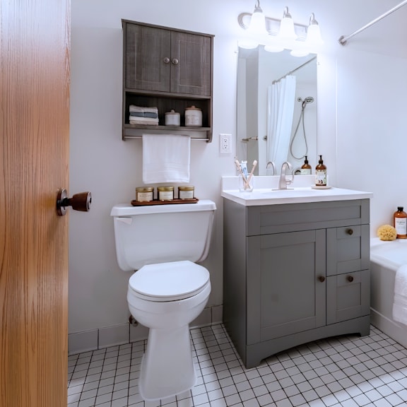 a bathroom with a white toilet and a white sink.