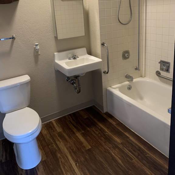 a white toilet sits next to a sink in a small bathroom.