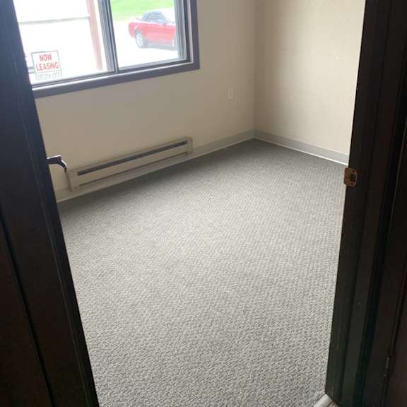 a room with a car parked outside the window.