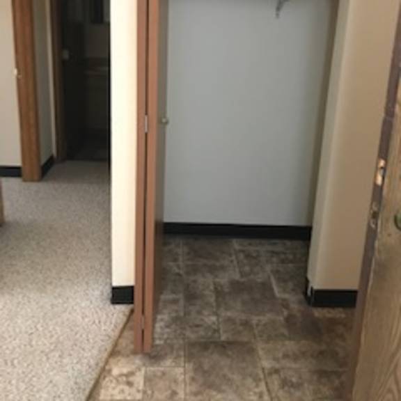 a white door is open in a hallway.