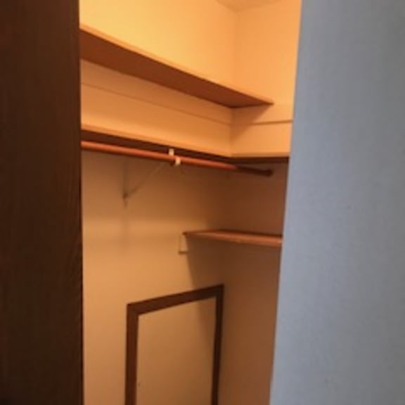 a white door is in a room with a brown floor.