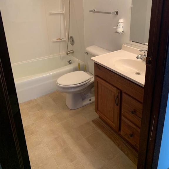 a white toilet sits in a bathroom next to a sink.