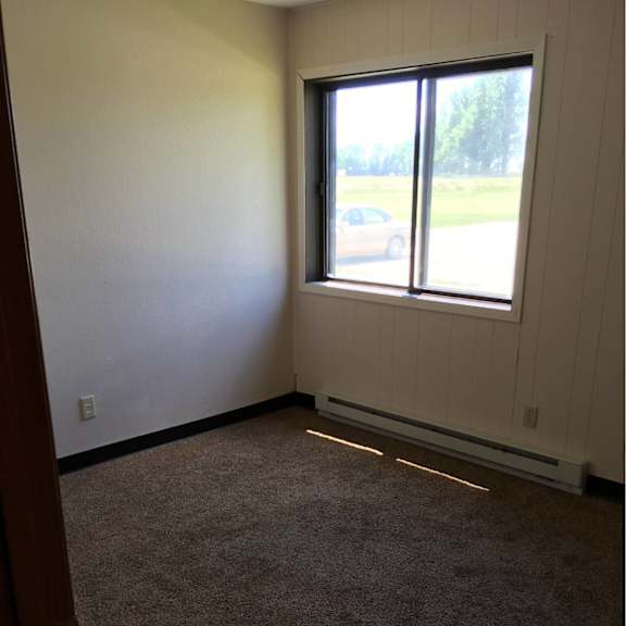 a room with a car visible through the window.