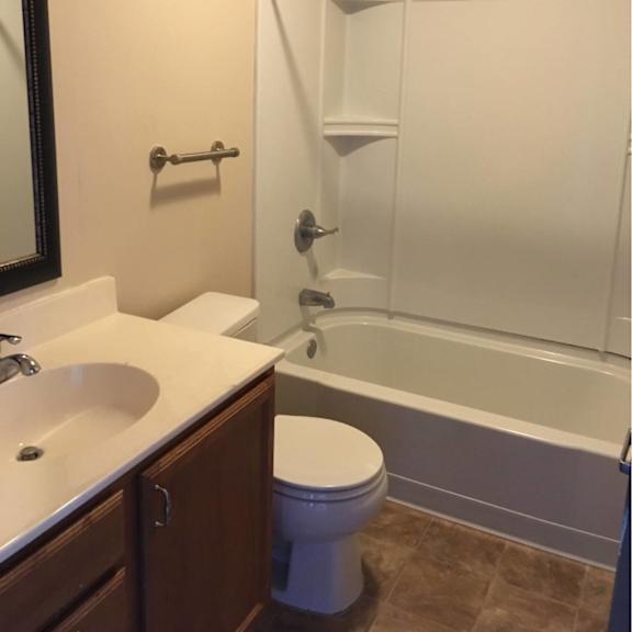 a white toilet sits next to a sink in a bathroom.