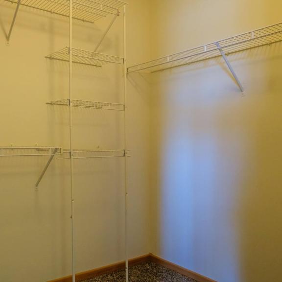 empty pantry with white walls and shelves.