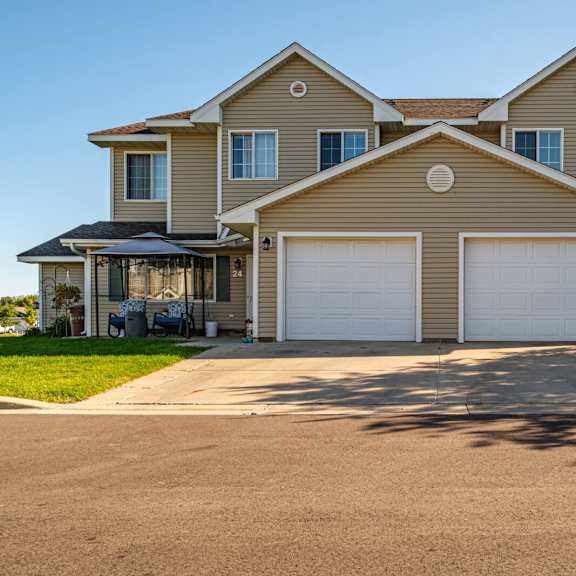 a large house with a driveway in front.
