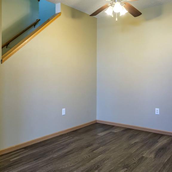 a room with a staircase and a ceiling fan.