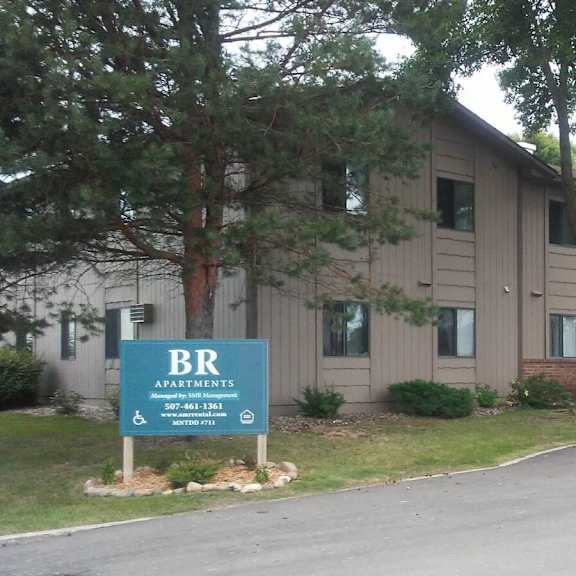 a building with a sign that says br apartments.