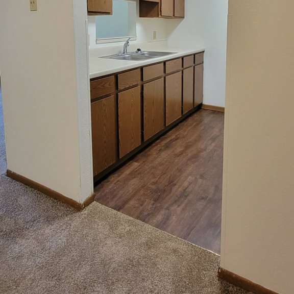 a kitchen with wooden cabinets and a sink.