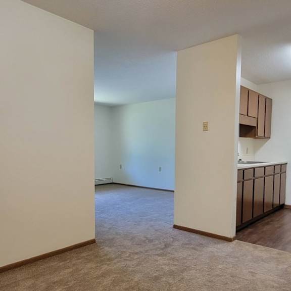 a room with a carpeted floor and a ceiling light.