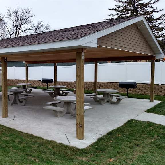 a covered picnic area with tables and benches.