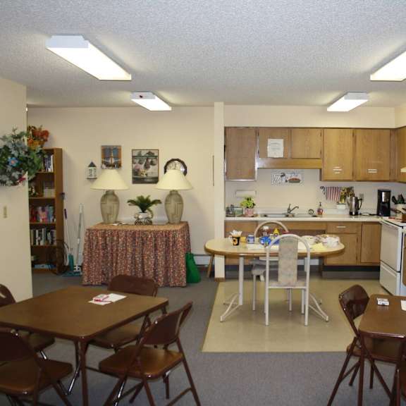 a kitchen with a table and chairs in the middle of the room.