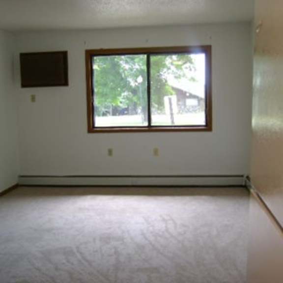 a room with a window and a flat screen tv on the wall.