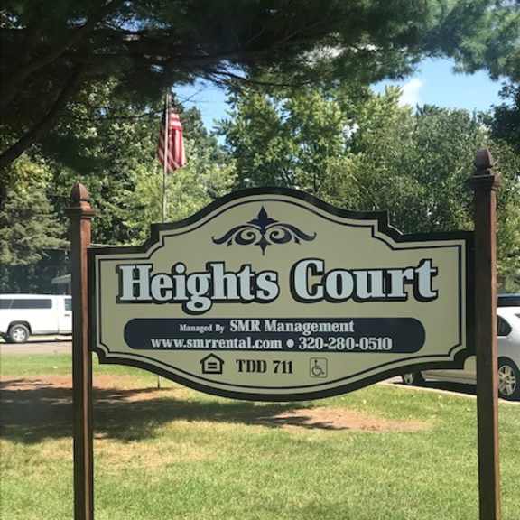 a sign for heights court managed by smr management with a website and phone number listed.