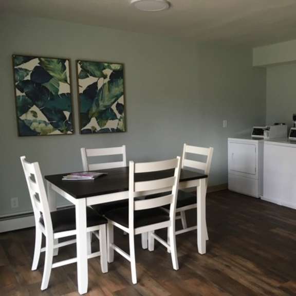 a dining room with a table and chairs.