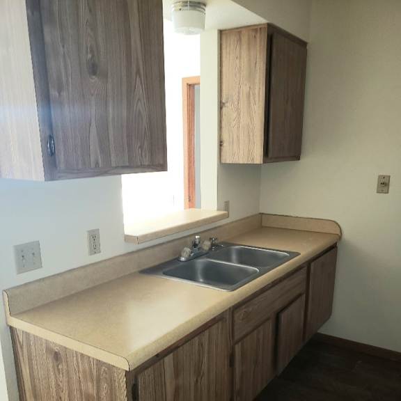 a kitchen with wooden cabinets and a sink.