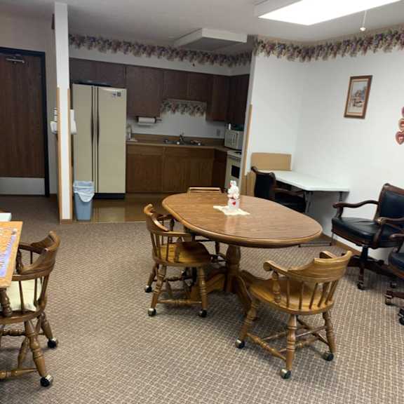 a kitchen area with a table and chairs.