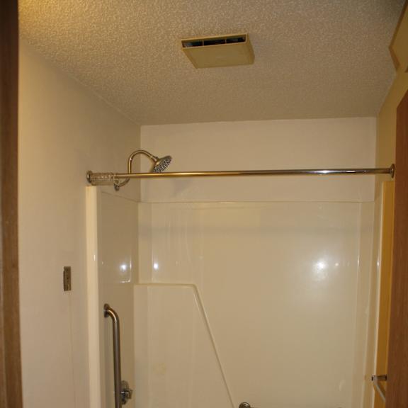 a white toilet sits in a bathroom next to a sink.