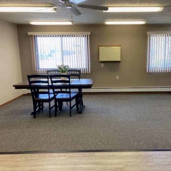 a room with a table, chairs, and a couch.