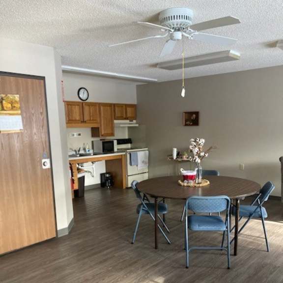 a dining room with a table and chairs.